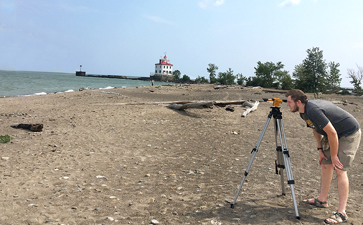 photo of Clay Kolke at the beach doing research